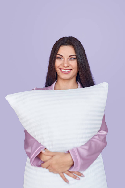Cheerful woman embracing pillow - Photo, image