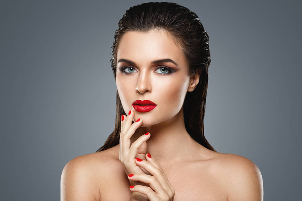 Portrait of beautiful young woman with a red lipstick and nail p - Zdjęcie, obraz