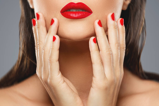 Beauty and cosmetics. Female mouth and nails with red manicure a - Valokuva, kuva