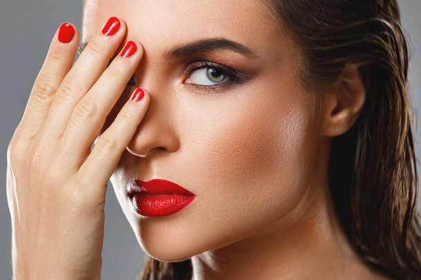 Portrait of beautiful young woman with a red lipstick and nail p - Φωτογραφία, εικόνα