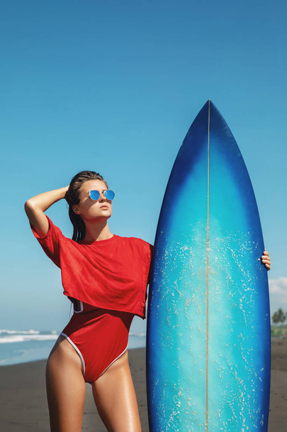 Sexy woman surfer with shortboard on the beach - Фото, изображение