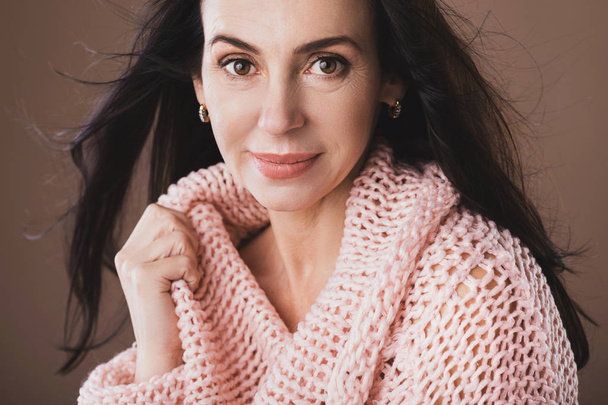 Portrait of beautiful middle aged woman wearing warm woolen swea - Foto, Imagen