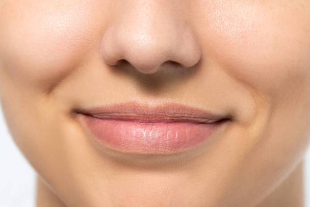Extreme close up of female mouth with charming smile. - 写真・画像