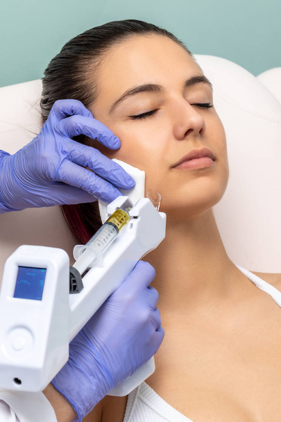 Woman having cosmetic facial plasma lift with micro needle gun. - Foto, Imagem
