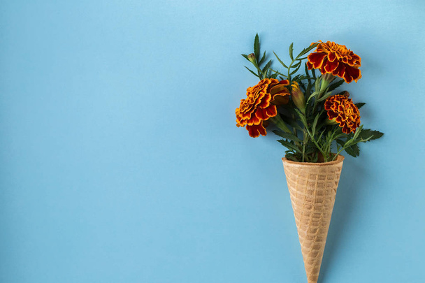 Flat lay Ice Cream Cone with of marigold flowers. - Fotoğraf, Görsel