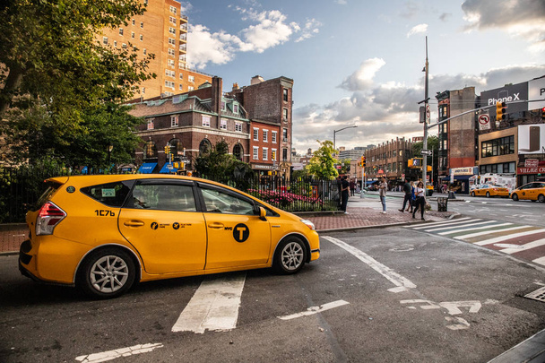 NEW YORK CITY - AUGUST 24, 2019:  Street scene for Greenwich Village, West Village in Manhattan with cars, people and taxi cabs.  - Fotó, kép
