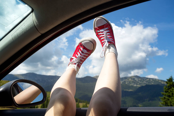 Girl legs sticking out of the car  - Фото, зображення