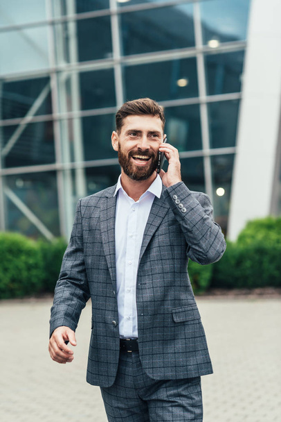 Joyful businessman dancing and talking phone about his new career - Foto, Imagem