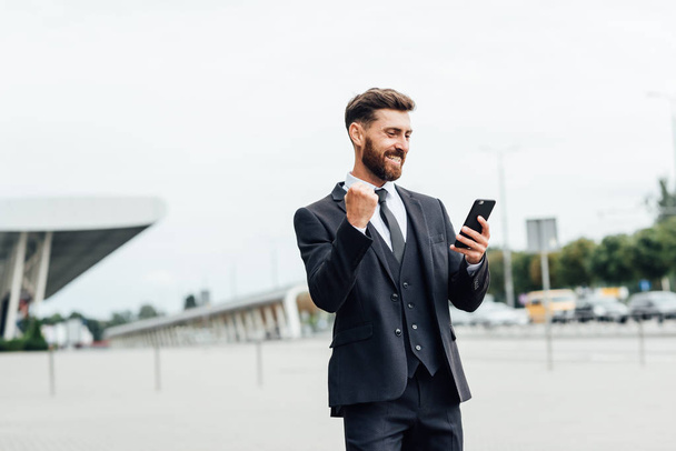 Smiling businessman using mobile phone - Photo, image