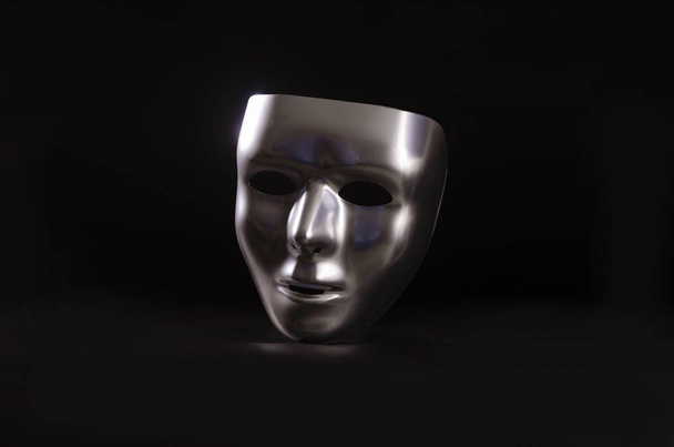 una máscara metálica brillante resaltada sobre un fondo negro de inicio
 - Foto, imagen