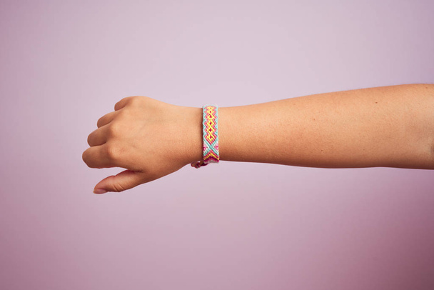 Model arm with beautiful handmade colorful bracelet on wrist - Foto, imagen