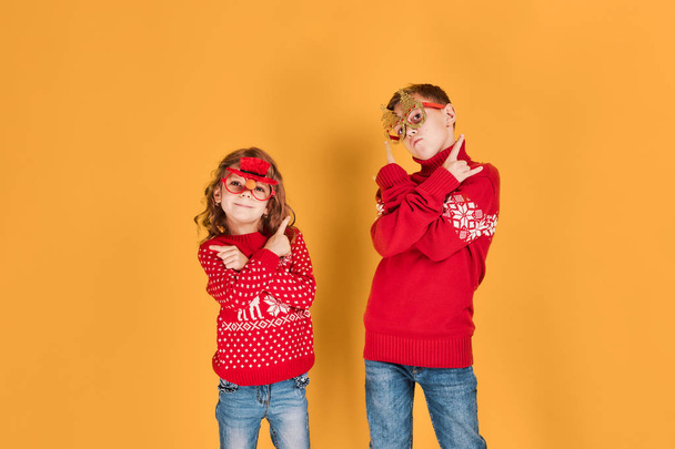 Children in warm red Christmas sweaters - Foto, Imagem