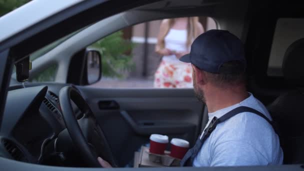 Female client taking coffee from delivery man - Footage, Video