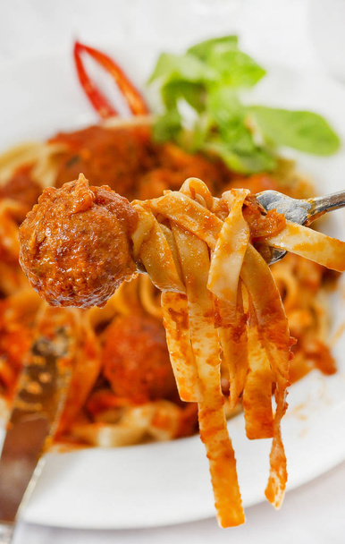 Fettuccine and Meatballs on a fork close-up. - Foto, Imagen