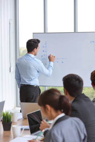 полная продолжительность тренинга для бизнесменов в командной встрече или тренинге, график рисования спикеров на белой доске (концепция бизнес-семинара
) - Фото, изображение