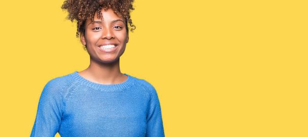 Beautiful young african american woman over isolated background Hands together and fingers crossed smiling relaxed and cheerful. Success and optimistic - Фото, зображення