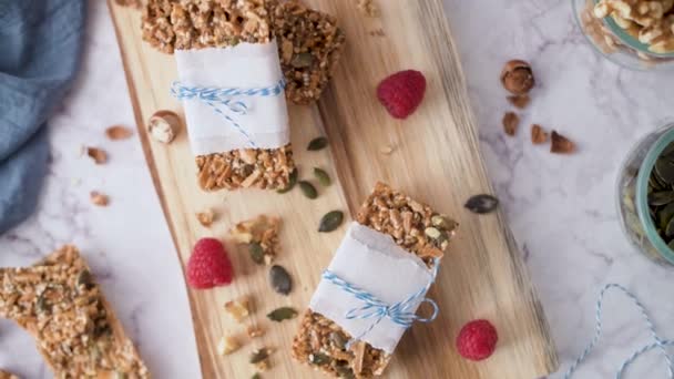 Organic homemade granola bars on rustic marble stone kitchen countertop. - Imágenes, Vídeo