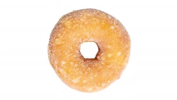 Vista superior de rosquillas de azúcar rosquilla girando sobre un fondo blanco
 - Imágenes, Vídeo