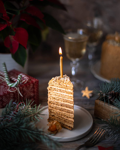Homemade honey cake. Winter composition. New Year photo. Christmas decoration. Christmas decorations. Cake with sparklers. Candles. - Photo, Image