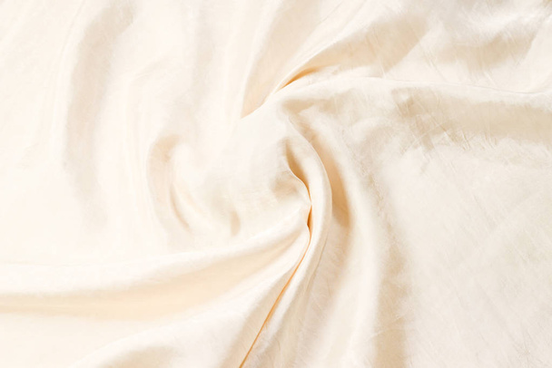 Soft smooth beige silk fabric background. Fabric texture.  - Photo, Image