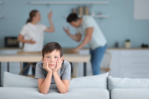 Sad little boy and his quarreling parents at home - Foto, Imagen