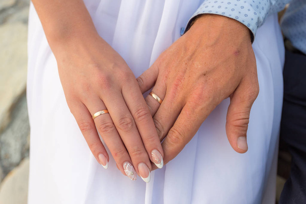 Wedding rings in the hands of the bride and groom - Photo, Image