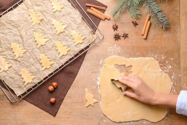 Woman preparing tasty Christmas cookies at table, top view - Fotografie, Obrázek