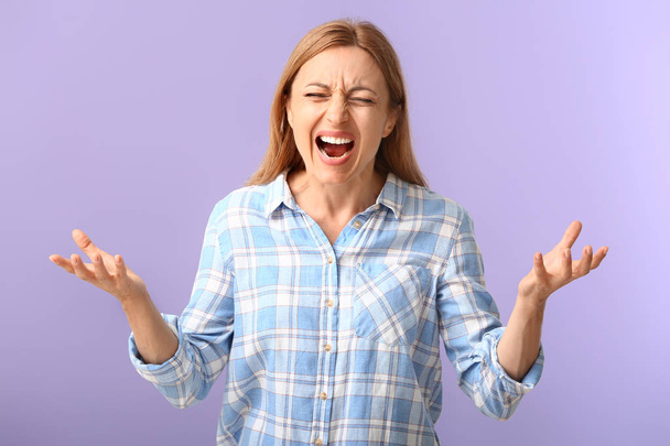 Stressed woman on color background - Foto, imagen