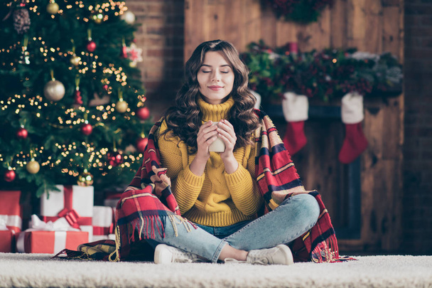 Full length body size photo of cheerful beautiful funny funky attractive nice cute girl smelling her drink wearing jeans denim yellow pullover enjoying coffee while sitting on floor - Foto, imagen
