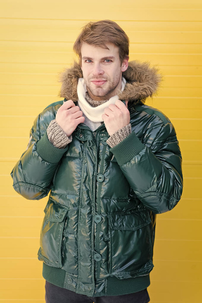 The perfect choice for cold days. Casual fashion coat for cold winter conditions. Handsome man wearing hooded coat. Fashionable man in cold weather style. Fashion model enjoys warmth and comfort - 写真・画像