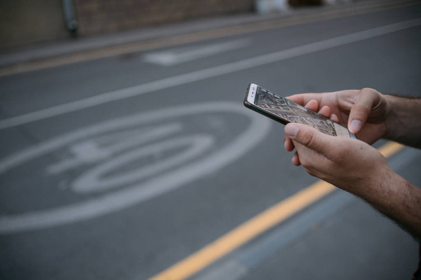 Male hands with the phone, navigation. Close-up.  - Φωτογραφία, εικόνα