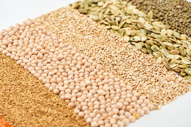 raw chickpea, buckwheat, maash and pumpkin seeds isolated on white - Photo, Image