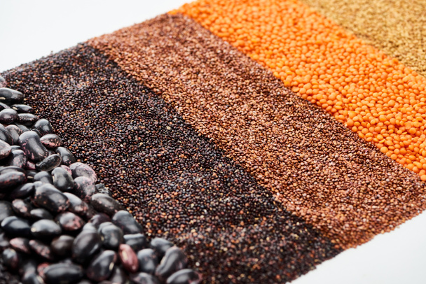 black quinoa, beans, buckwheat and red lentil isolated on white - Photo, Image