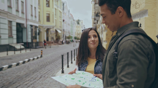 interracial couple pointing with finger on map - Filmmaterial, Video