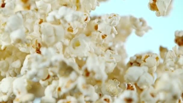 Super slow motion of falling popcorn on coloured background. Filmed on high speed cinema camera, 1000fps. - Materiał filmowy, wideo