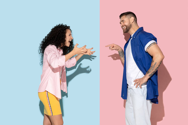 Young emotional man and woman on pink and blue background - Photo, Image