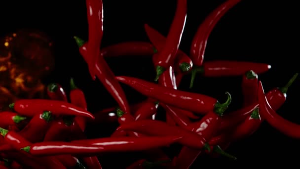 Super slow motion of flying red hot chilli peppers in fire. Filmed on high speed cinema camera, 1000 fps - Video, Çekim