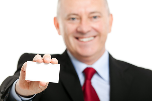 Mature businessman holding a business card - Foto, afbeelding