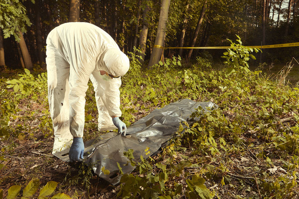 Collecting of human remains to plastic body bag by police technician for observing - Zdjęcie, obraz