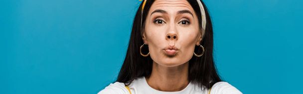 panoramic shot of girl with duck face isolated on blue  - Фото, зображення