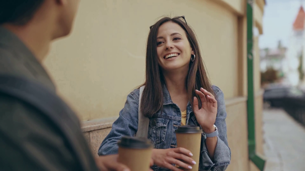 woman talking and drinking coffee with bi-racial man - Filmmaterial, Video
