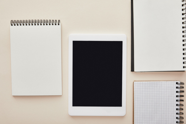 notebooks near digital tablet with blank screen isolated on beige  - Foto, Imagen