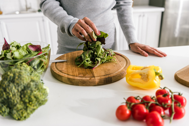 selective focus of woman preparing salad in kitchen  - Photo, Image