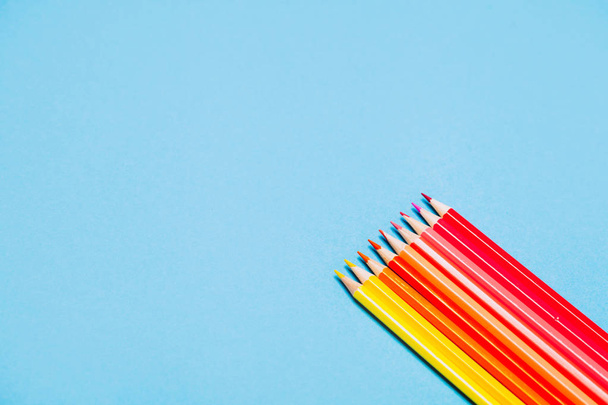 Colorful pencils on blue background. Copyspace. - Photo, Image