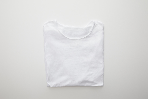 top view of plaid folded t-shirt on white background - Φωτογραφία, εικόνα