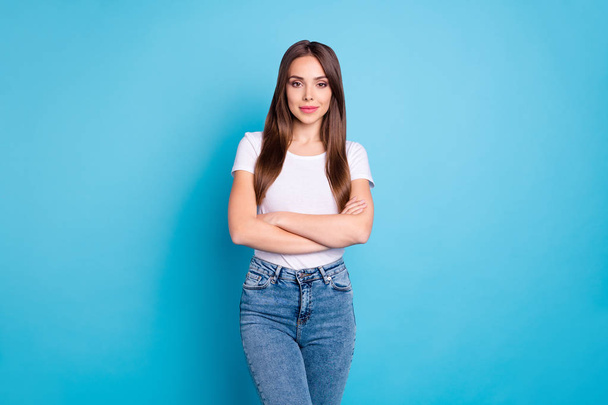 Portrait of pretty youngster with crossed arms looking wearing white t-shirt denim jeans isolated over blue background - Fotografie, Obrázek