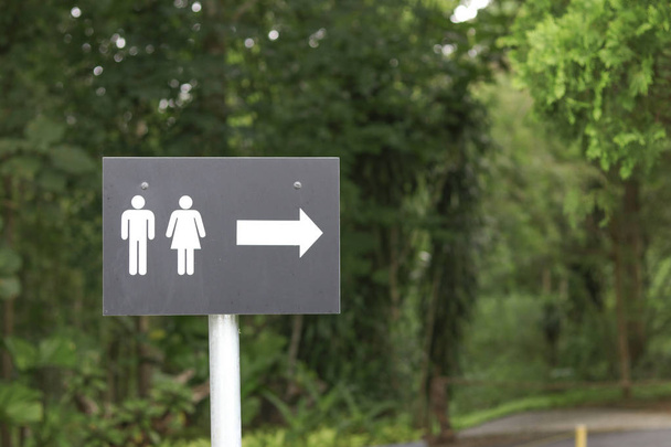 A sign with a male and female symbol showing the way to the restroom. Sign indicating the way to the toilet. - Photo, Image