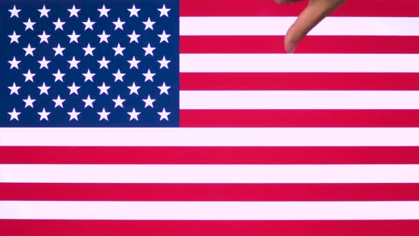 Hand giving thumb down with Usa flag, disapproval gesture with copy space. Negative opinion sign, contempt for American nation banner background, disliking symbol United States with blank field - Footage, Video