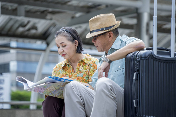 Old couples looking at the map to find travel destinations Travel after retirement - Photo, Image