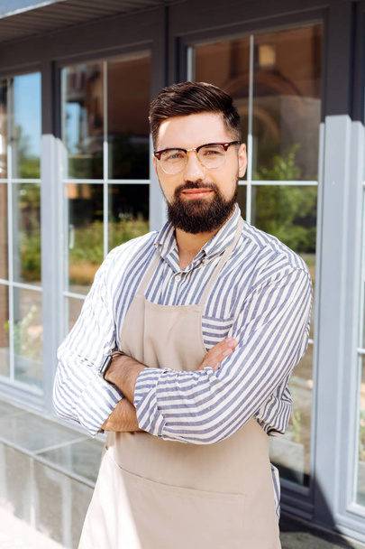 Handsome bearded man standing in front of his restaurant - Photo, image